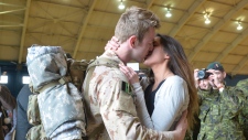 Um beijo de saudade entre Anthony Alliot e Sarah, no regresso das últimas tropas canadianas do Afeganistão. (The Canadian Press/Adrian Wyld)