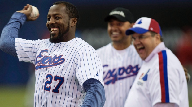 O ex-jogador dos Montreal Expos, Vladimir Guerrero, atira uma bola de basebol ao lado do presidente de Montreal Denis Coderre e o ex-companheiro Orlando Cabrera, durante uma cerimónia pré-jogo dos Toronto Blue Jays contra os Cincinnati Reds, no jogo de exibição da MLB - 3 de abril, 2015, em Montreal. THE CANADIAN PRESS/Paul Chiasson