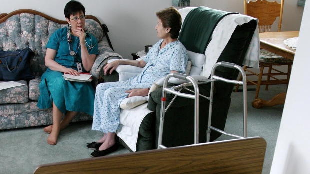 A médica de cuidados paliativos Anna Taube (à esquerda) visita a paciente com cancro, Maggie Halabi, em Edmonton, nesta foto de arquivo. (FOTO CP / John Ulan)