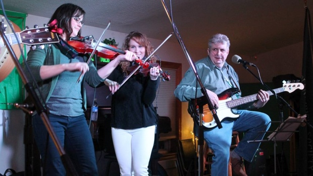 Garth Matthews em palco com as violinistas Sheila Mackenzie e Courtney Hogan. (Garth Matthews/Facebook)
