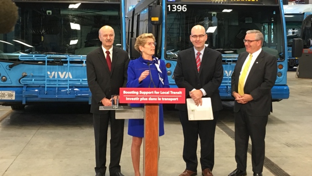 A primeira-ministra do Ontário Kathleen Wynne anuncia que o seu governo duplicará a quantia de dinheiro que a província concede às agências de trânsito locais do imposto sobre os combustíveis. Ela é ladeada por, da esquerda: Reza Moridi, MPP para Richmond Hill, Ministro dos Transportes Steven Del Duca e Chris Ballard, MPP para Newmarket-Aurora. (Mike Crawley / CBC)