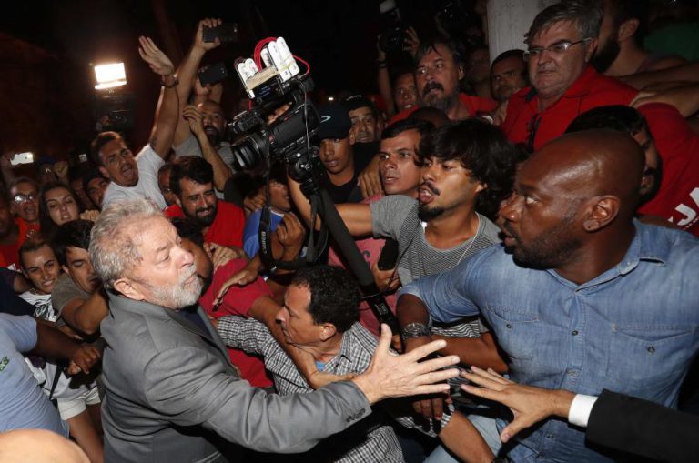 LULA DA SILVA SAI A PÉ DO SINDICATO, RODEADO DE SEGURANÇAS