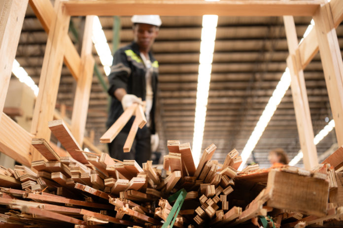 A carpenter works in a wooden factory, Gather wood that has pass
