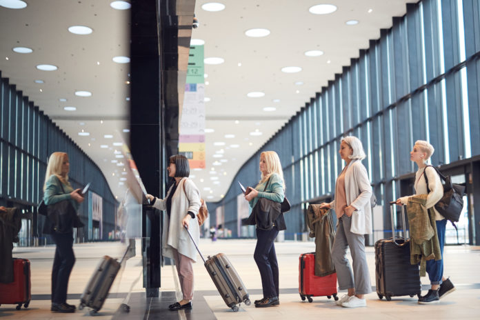 Women In Queue At Check-In Counter