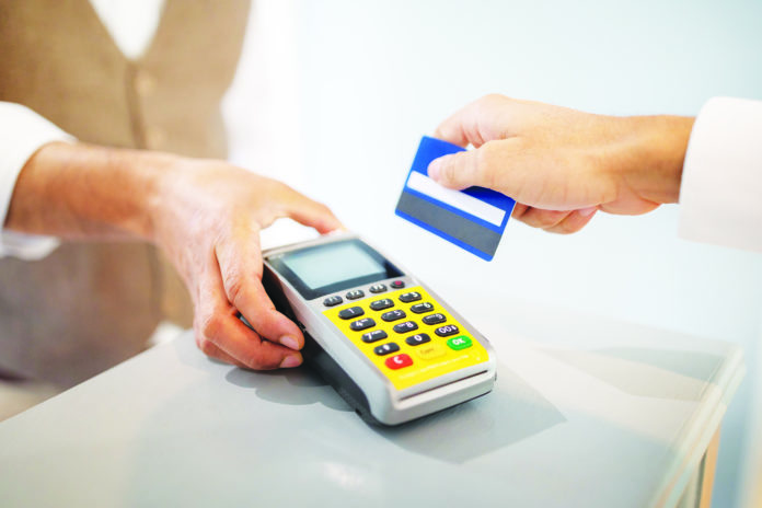 Customer Man Swiping Credit Card Paying Via Terminal Indoor, Closeup