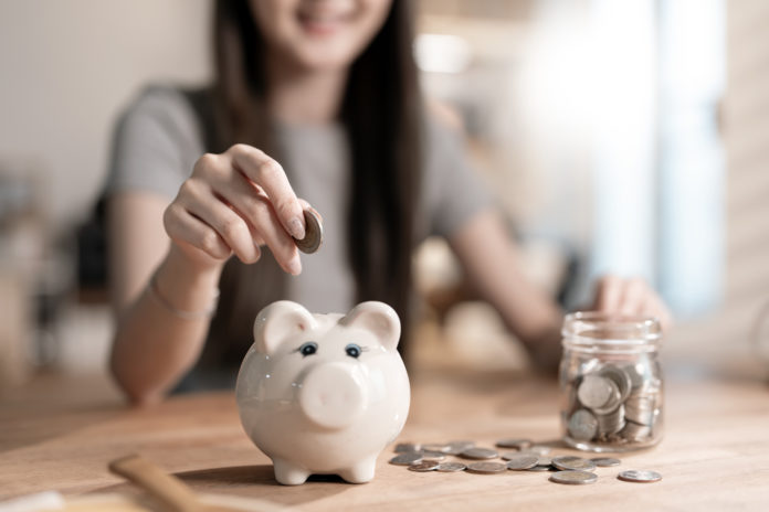 Saving money wealth concept, asian young business woman hand put