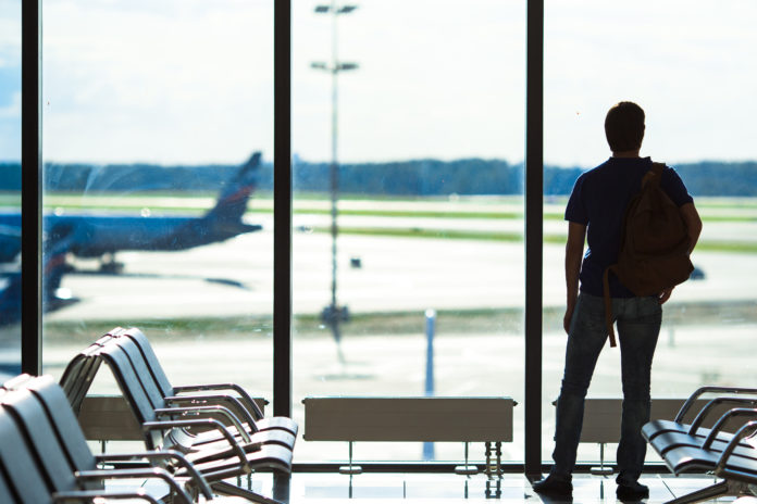 Silhouette of a man waiting to board a flight in airport