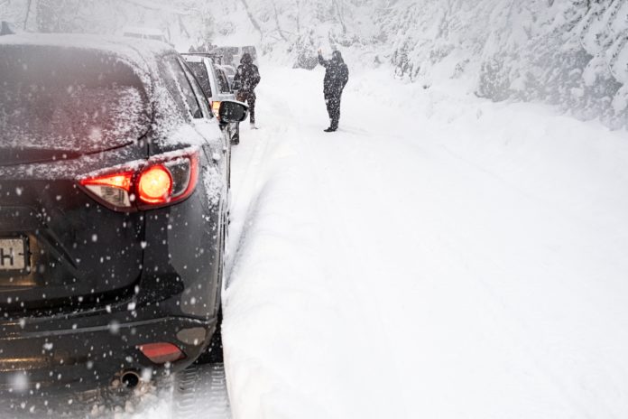 Russia, 4 january 2022. Traffic jam in heavy snowfall on mounta