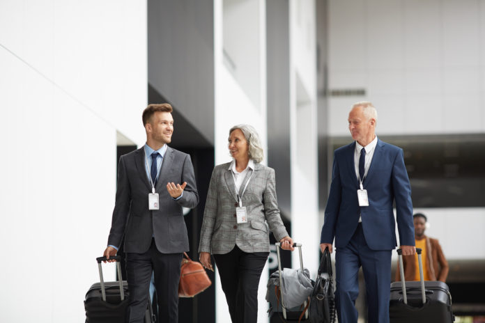 Company managers with luggage in airport
