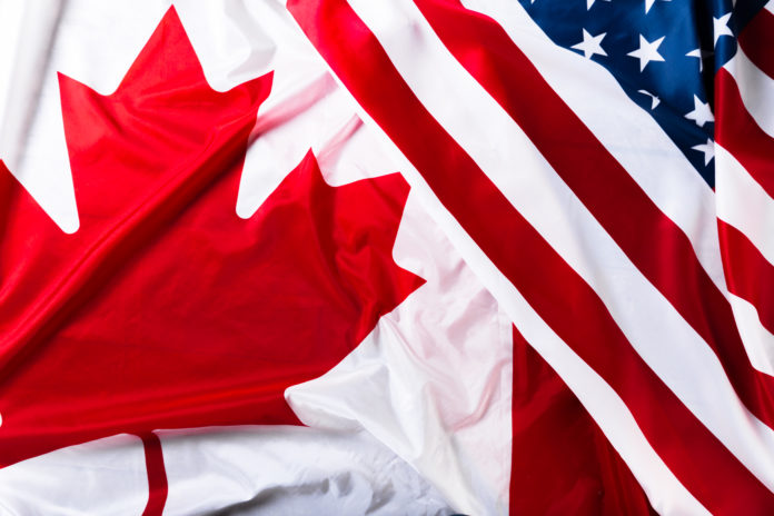 American and Canadian flags together