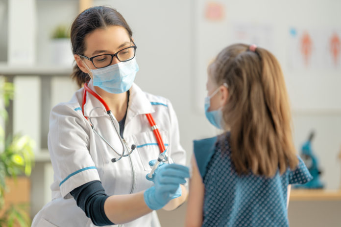 Doctor vaccinating child