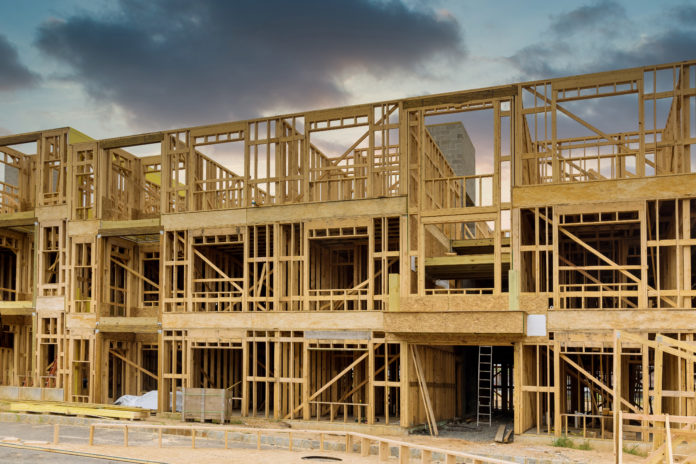 Fragment of a new home under construction wood framing beams