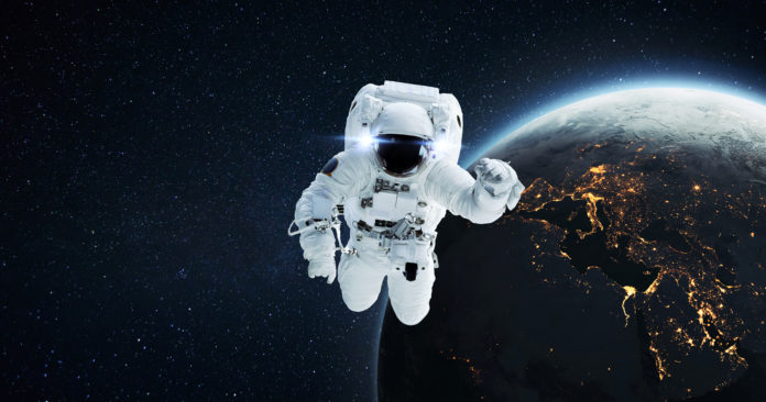 Space man astronaut flying in outer space with amazing night pla