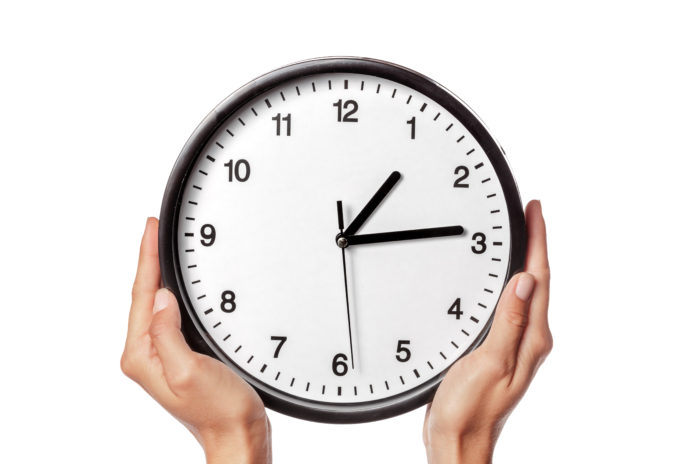 clock in hands isolated on white. creative photo.